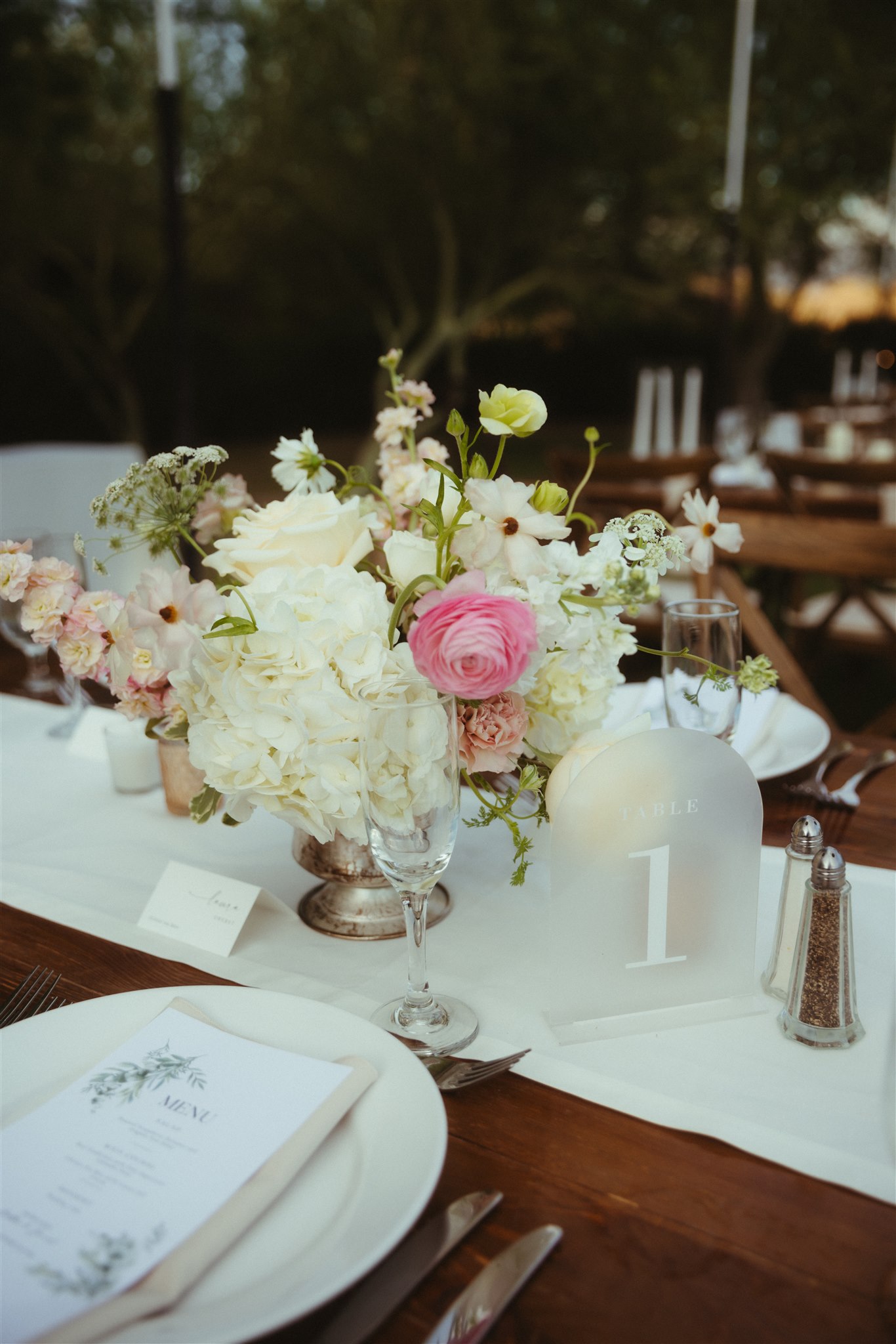 Candlelit reception place setting with floral details