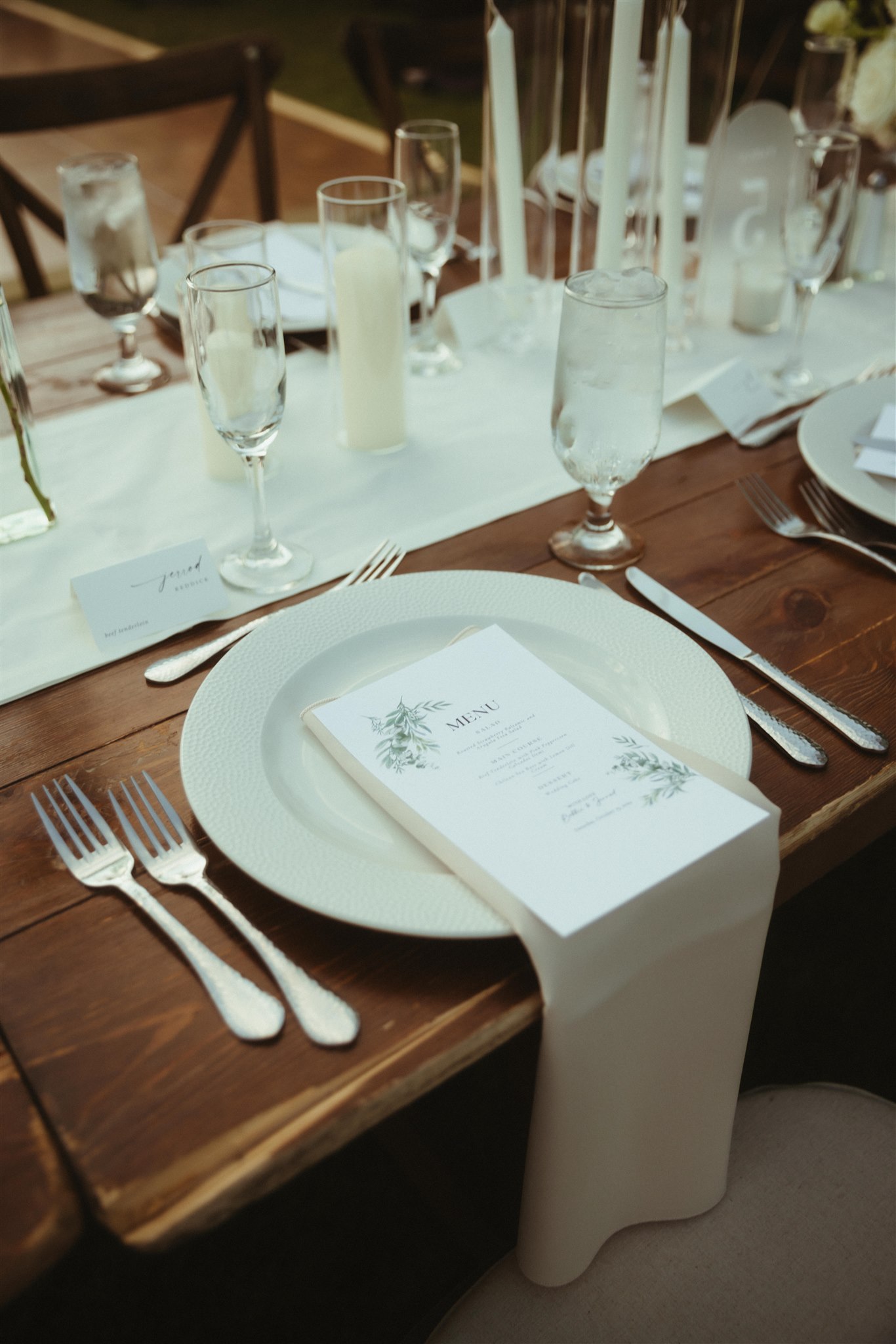 Outdoor wedding table styled with flowers and candles