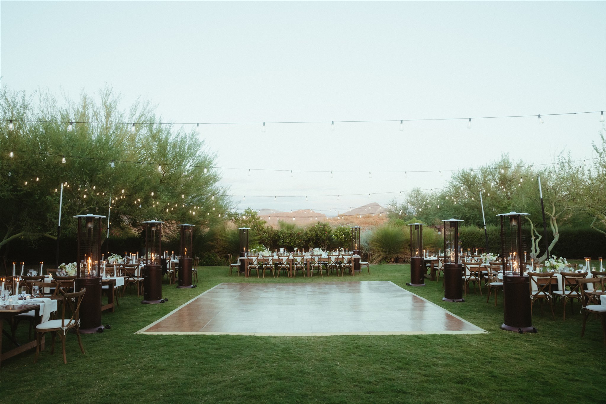 Wide view of the al fresco wedding dinner
